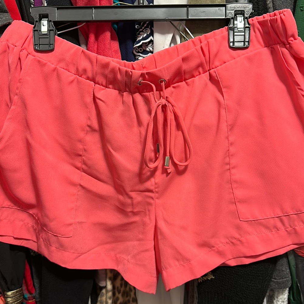 Coral color shorts.